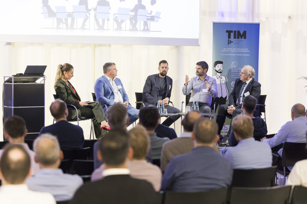 Podiumsdiskussion bei der Veranstaltung DRIVING CHANGE im RITZ mit mehreren Expertinnen und Experten auf der Bühne.